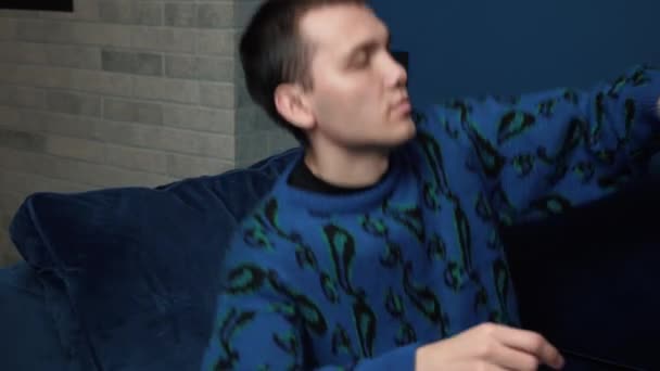 Handsome caucasian man walking to sofa and lay down to take a rest after hard work. Caucasian man relaxed and sleep on sofa at home.  - Footage, Video
