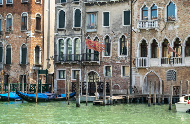 Italy, Venice July 23, 2020: Editorial Image of Famous Italian Venice in Summer with Ancient Venetian Flag on House over the Grand Canal - 写真・画像