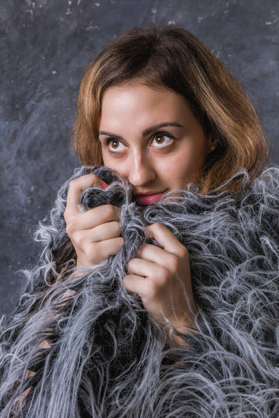 Pretty young woman dressed in fur coat - Fotografie, Obrázek