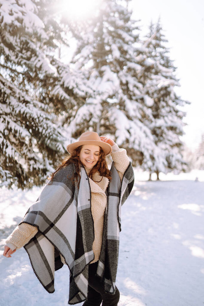 Young woman  enjoying winter weather in the snow forest.  Cold weather. Winter fashion, holidays, rest, travel concept. - Φωτογραφία, εικόνα