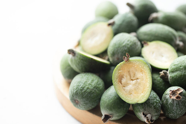 Feijoa green on a light background. Feijoa Selloana is a fruit crop from tropical regions. Organic healthy food concept, eco friendly natural products, vegetarian, raw products. - Photo, Image