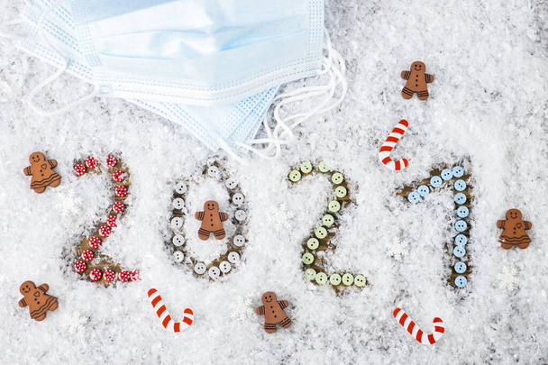 New Year 2021. Numbers in the snow. Decorative jewelry and medical mask. - Zdjęcie, obraz