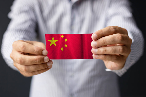 Flag of China. Close-up of man holding China flag.  - Photo, image