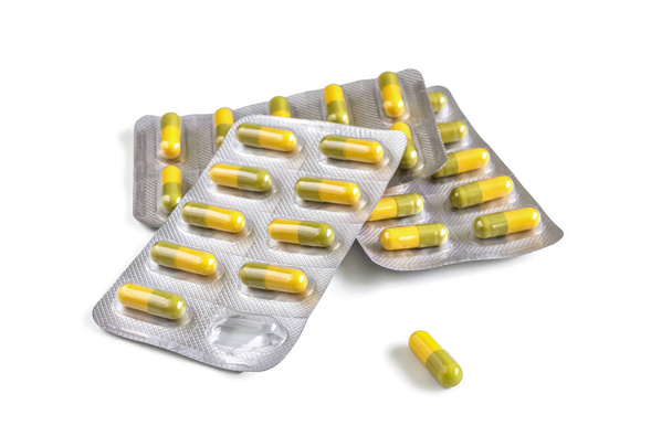 Envases blíster con cápsulas de gelatina amarilla aisladas sobre fondo blanco - Foto, Imagen