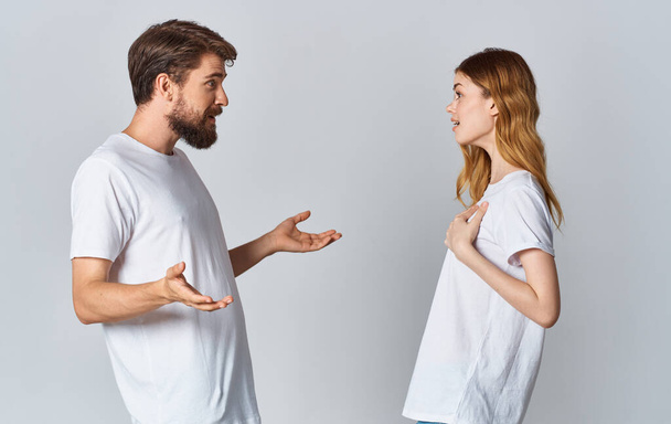 handsome guy explains something to a young woman on a light background cropped view family Copy Space - Foto, imagen