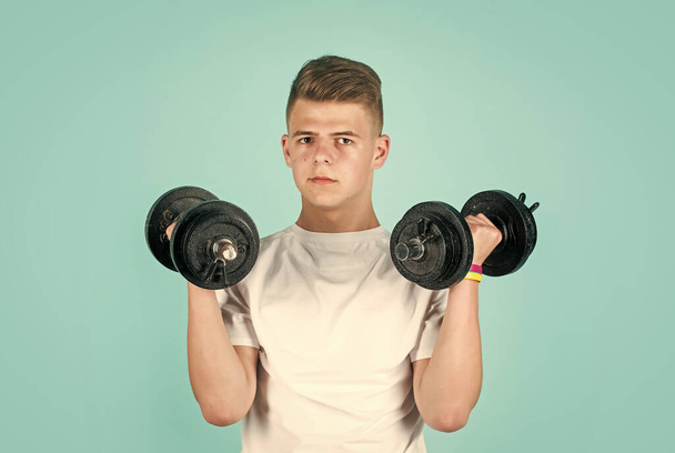 Achieve only best results. sportswear equipment shop. healthy lifestyle. dieting for athletics. strong man workout in gym. teen boy training with barbells. sport and fitness. teen guy hold dumbbell - Foto, Imagem
