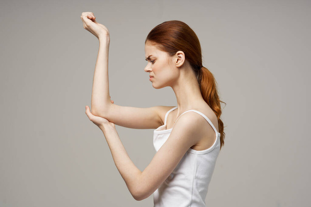 disgruntled woman elbow pain massage health studio - Фото, изображение