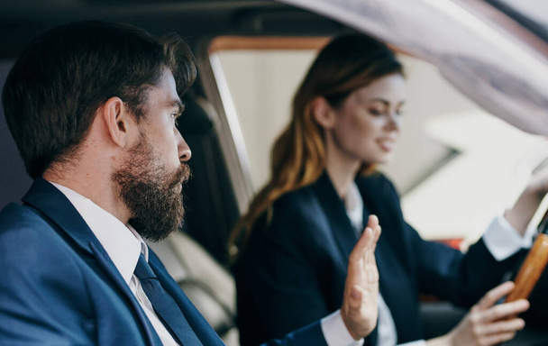 business man and woman sitting in a car salon communication emotions - Photo, Image