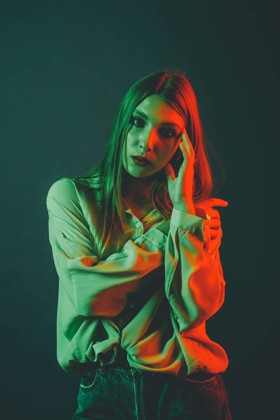 Creative portrait of a beautiful female model close-up. orange and green lighting in the Studio. - Fotografie, Obrázek