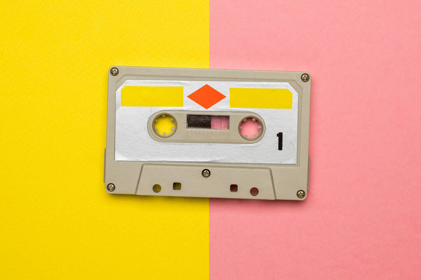Stylish vintage tape recorder on a yellow and pink background. - Photo, Image