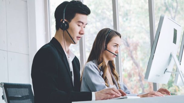 Business people wearing headset working in office - Фото, зображення
