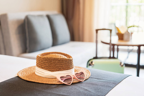 Hat and sunglasses with luggage in hotel room, Travel concept - Fotoğraf, Görsel