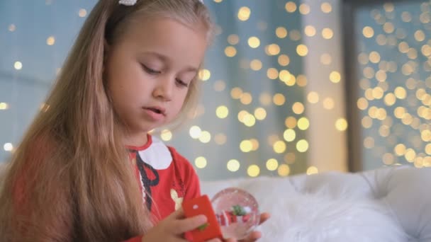 Samotna dziewczyna trzymająca świąteczną zabawkę, brak miłości i uwagi rodziców, samotność i zaniedbanie, smutne wakacje, nieszczęśliwe dzieciństwo - Materiał filmowy, wideo