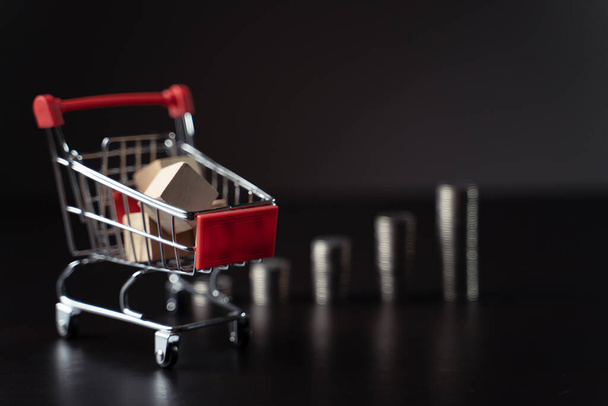 Financial marketing concept mini shopping cart with coins stack. - Photo, Image