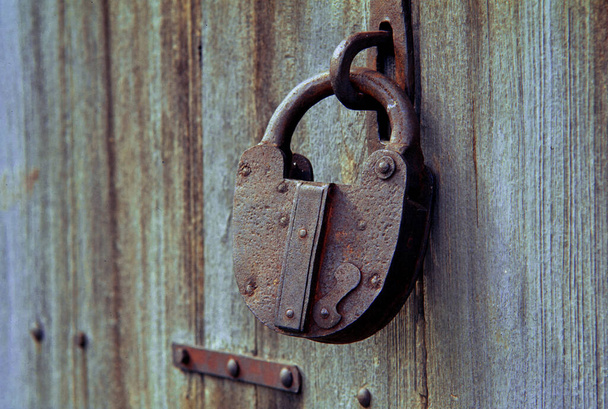 09-Apr-2005-Old Antique rusty vintage lock on weathered wood Kalyan near maharashtra INDIA asia - Photo, Image