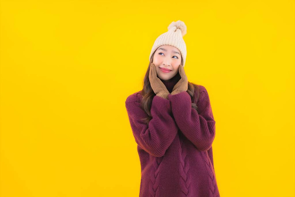 Portrait beautiful young asian woman smile happy in other action on yellow isolated background - 写真・画像