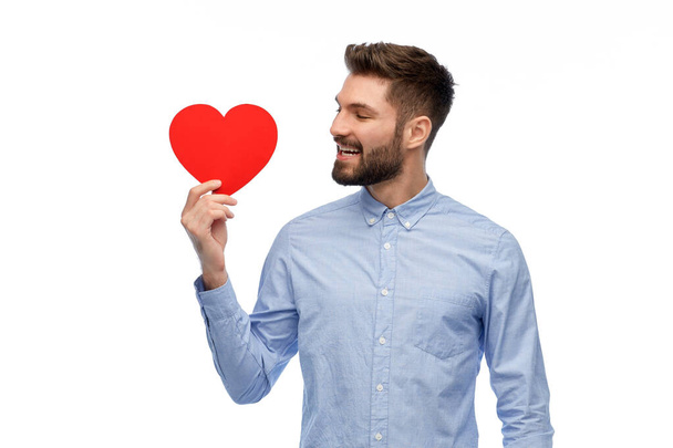 happy smiling young man with red heart - Φωτογραφία, εικόνα