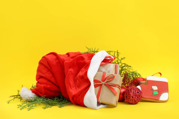 Santa Claus bag full of gifts on color background - Photo, image