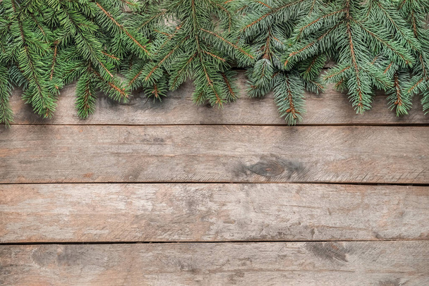 Christmas tree branches on wooden background - Fotografie, Obrázek