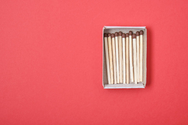 matches box on a red background top view copy space - Foto, Imagen