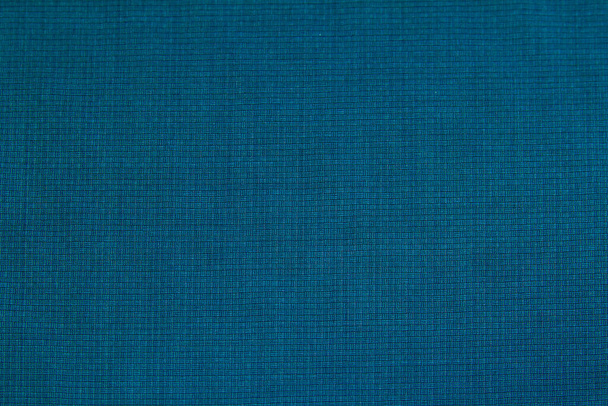 Background of blue wool fabric in a small cage for autumn and winter wardrobe. Horizontal orientation - Photo, Image