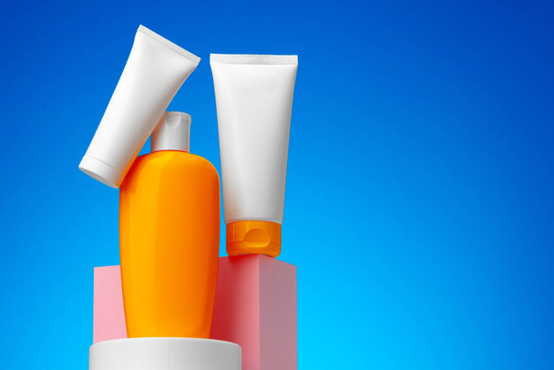 Skincare beauty products container against blue background - Foto, imagen