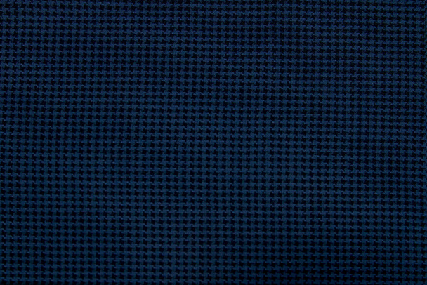 Un primer plano del fondo hecho de tela texturizada de lana azul-negra es adecuado para el guardarropa de otoño e invierno. Orientación horizontal - Foto, Imagen