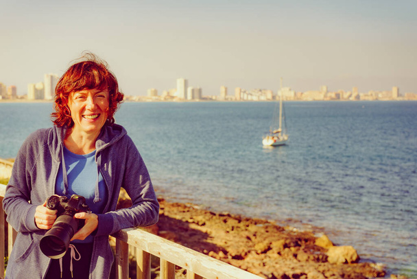 Tourist woman visit Cape Palos, Cartagen Murcia region, Spain. Female taking travel picture with professional camera, enjoy La Manga sea view. - Фото, изображение