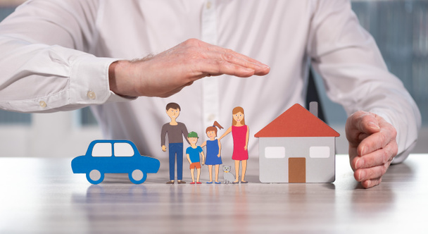 Family, house and car protected by hands - Concept of life, home and auto insurance - Foto, Imagen