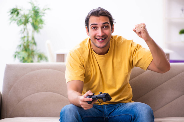 Young man playing joystick games at home - Photo, Image
