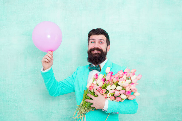 Valentines day party. Happy hipster hold tulips and party balloon. Bachelor party. Holiday decoration. Celebrating womens day. Birthday celebration. Wedding anniversary. Let party begin - Foto, afbeelding