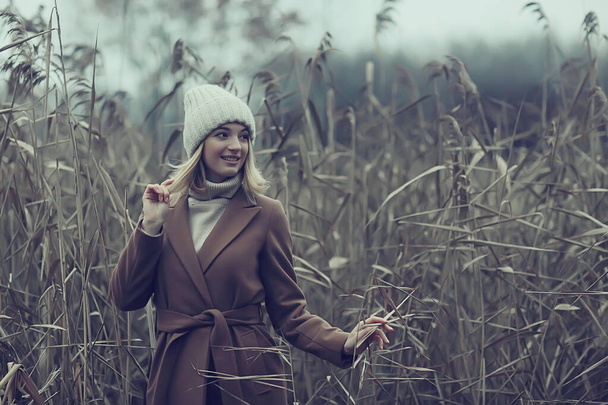 autumn fashionable portrait romantic girl in grass, travel seasonal look - Фото, изображение