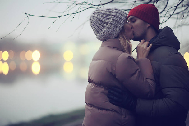 couple in love winter evening hugging outside, seasonal abstract background, weather twilight rain - Zdjęcie, obraz