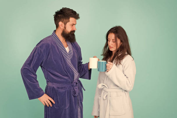 getting fresh. morning starts with coffee. first steps of family life. man and woman have breakfast together. couple in love drink cup of tea. morning at home. feeling cosy in robe. source of energy. - Фото, изображение