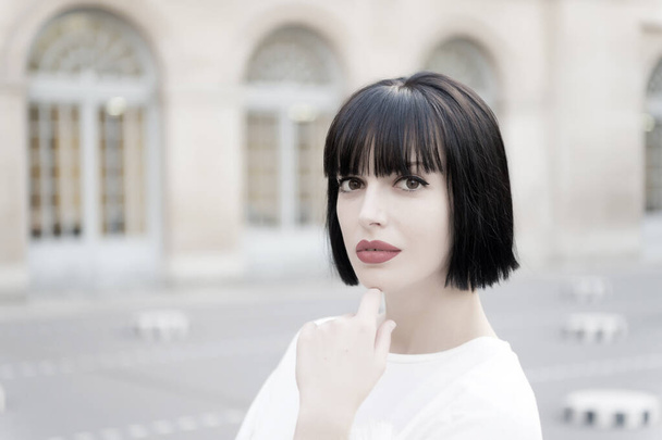 Woman with brunette hair and red lips makeup face in Paris, France - Foto, Imagen