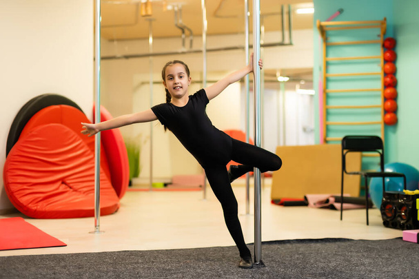 closeup of little gymnast girl doing exercises - Valokuva, kuva