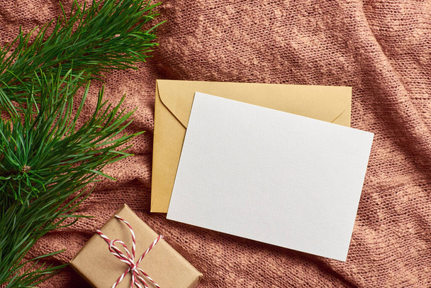 Greeting card mockup with gift box and pine tree branch - Foto, Imagem
