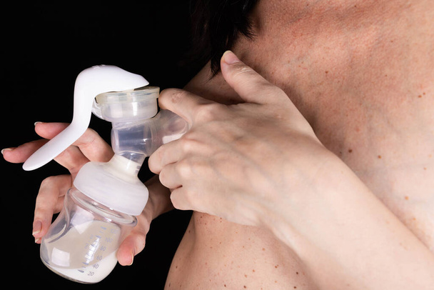 young woman expresses breast milk with a manual breast pump. Concept of breastfeeding - Foto, Imagem