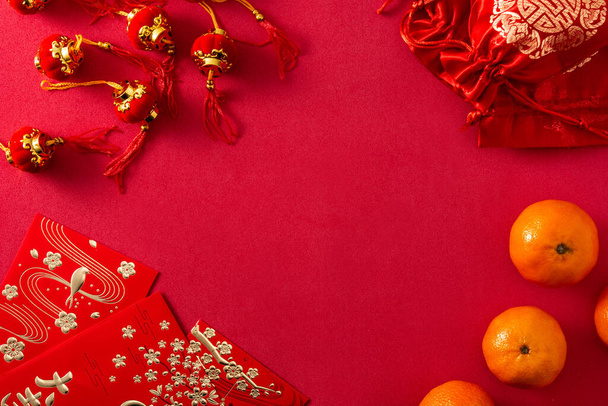 Chinese new year festival decorations and oranges on red background. Copy space - Fotoğraf, Görsel