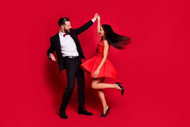 Full length photo of two positive persons dancing have great time isolated on red color background - Photo, image