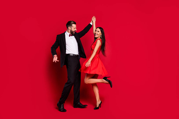Full body portrait of carefree handsome guy attractive lady have fun enjoy dance isolated on red color background - Fotó, kép