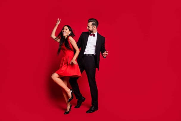 Full size photo of two persons enjoy dance clubbing lady wear stilettos isolated on red color background - Valokuva, kuva