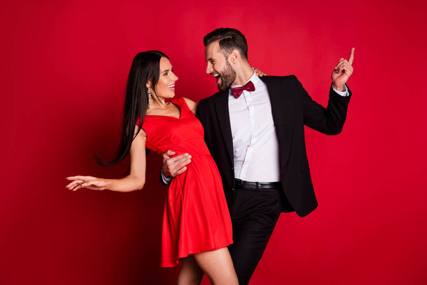Profile photo of funny optimistic couple dancing wear suit dress isolated on red color background - Fotoğraf, Görsel