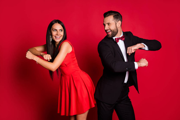 Portrait of positive attractive lady handsome guy excited dancing good mood isolated on red color background - Φωτογραφία, εικόνα