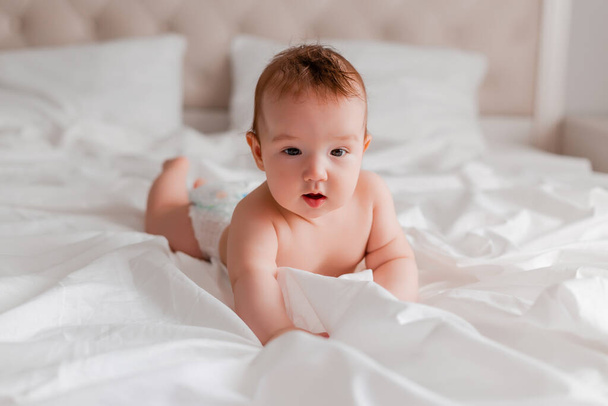portrait of baby boy lying on bed - Photo, Image