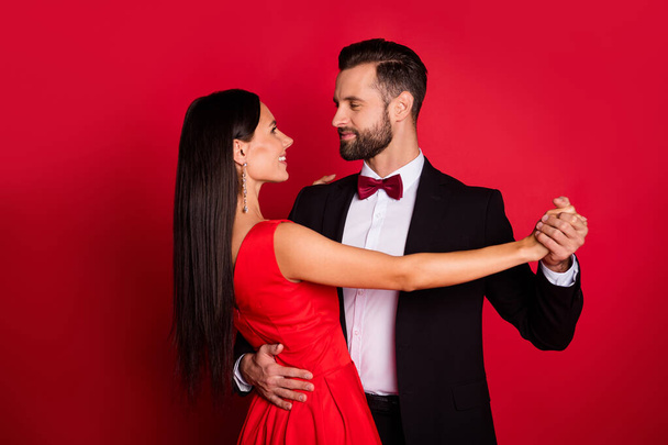 Profile photo of nice couple dance wear suit dress isolated on red color background - Foto, Bild