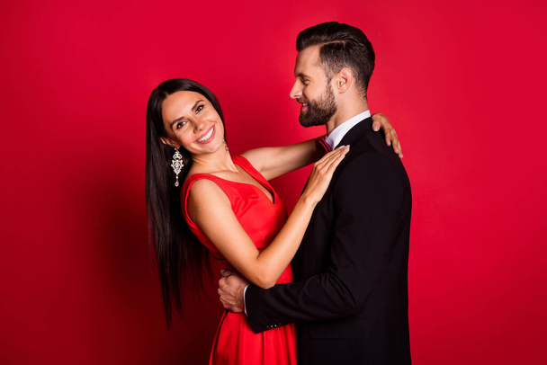 Profile photo of optimistic couple dance wear suit dress isolated on red color background - Fotó, kép