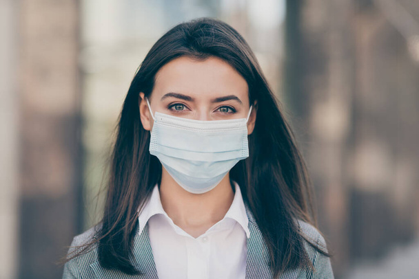 Photo of attractive young business person work in pandemic wear medical mask protection in outdoors - 写真・画像