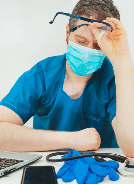 Tired medical doctor in protective mask. Burnout at work. - Fotó, kép