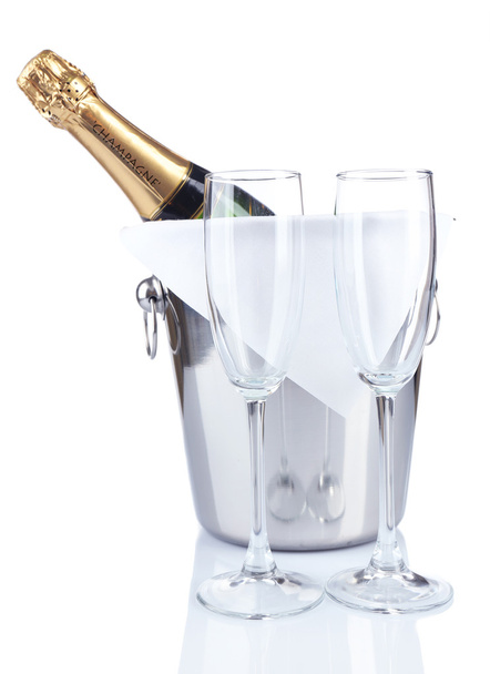 Bottle of champagne in pail and empty glasses, isolated on white - Foto, Imagem